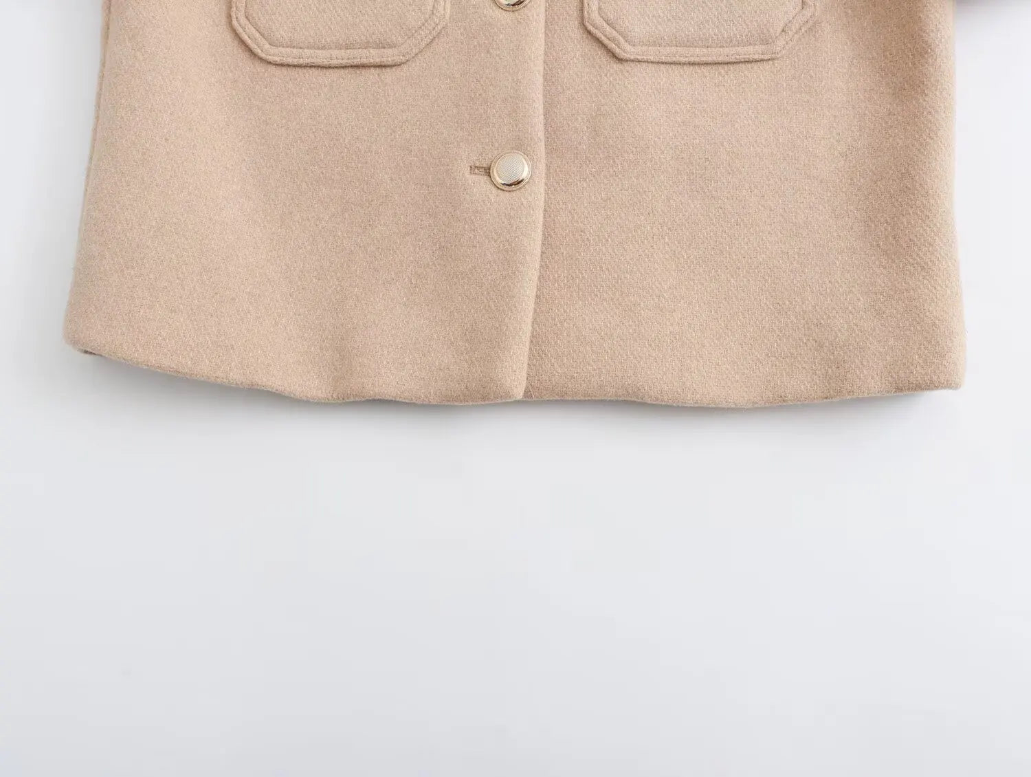 Beige button-up shirt on a light gray background