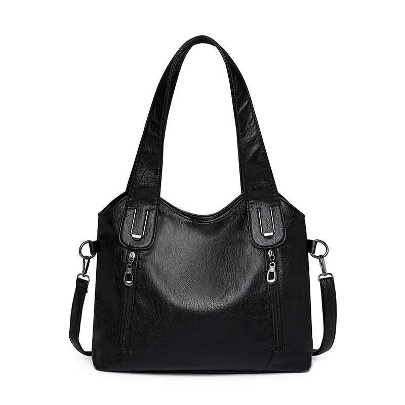 Black handbag with multiple pockets and straps on a white background