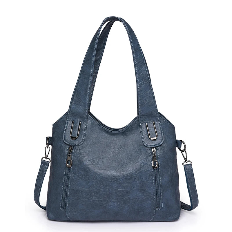Blue handbag with multiple straps on a white background