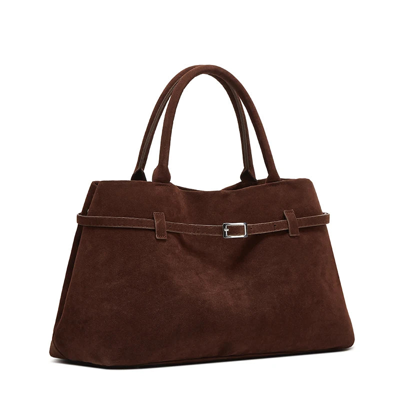 Brown handbag with a strap on a white background