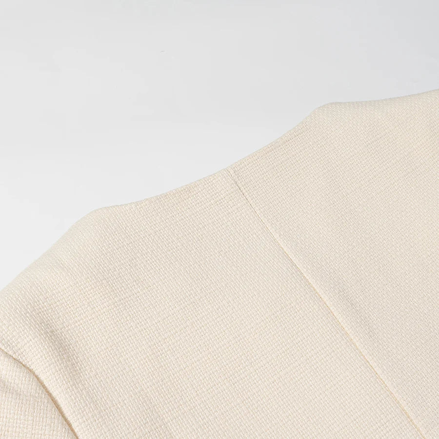 Close-up of a beige fabric texture on a light gray background