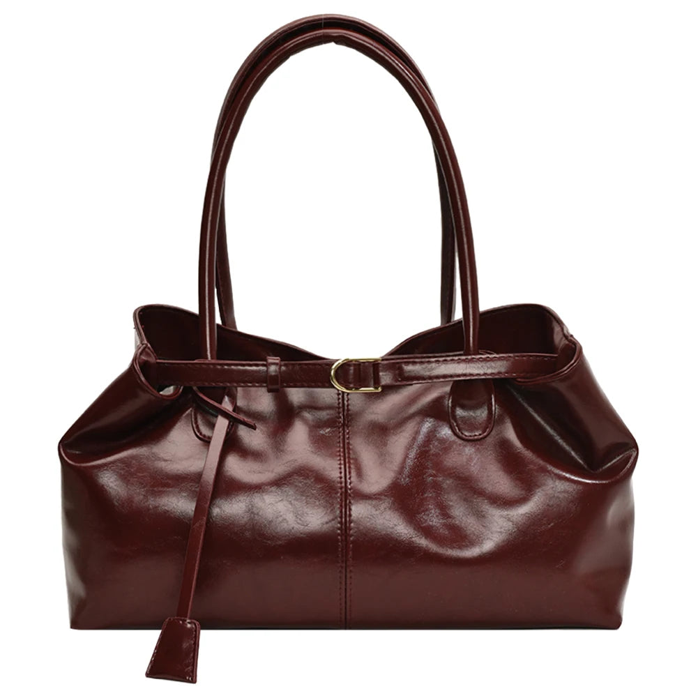 Brown leather handbag with a strap on a white background