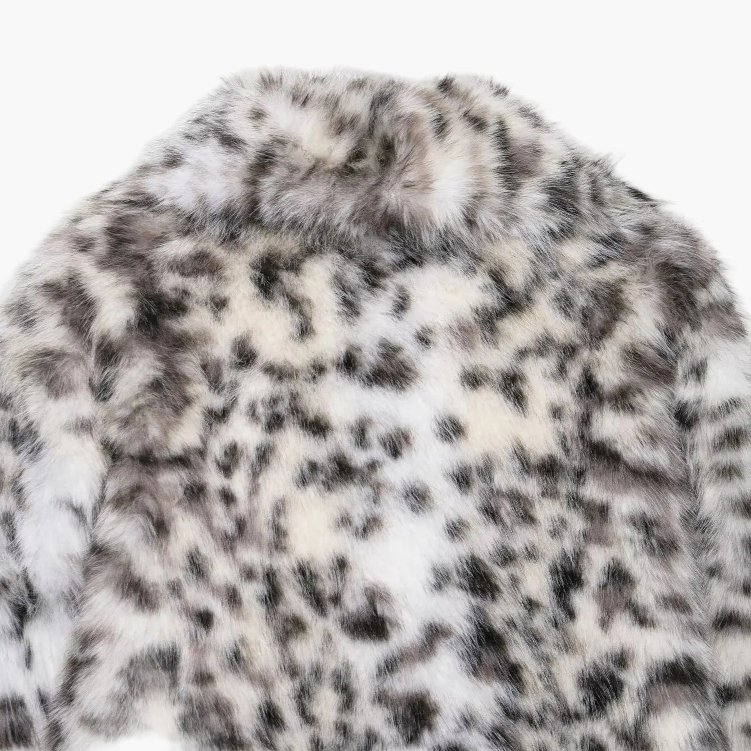 Close-up of a fur coat with a snow leopard pattern on a white background