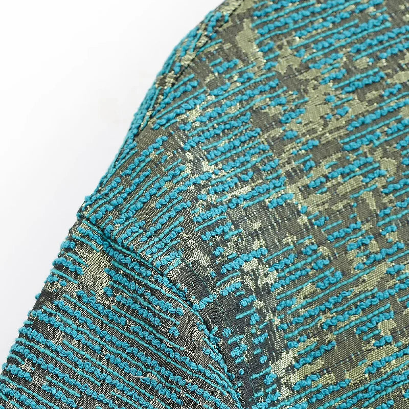 Close-up of a textured fabric with blue and gray pattern on a white background