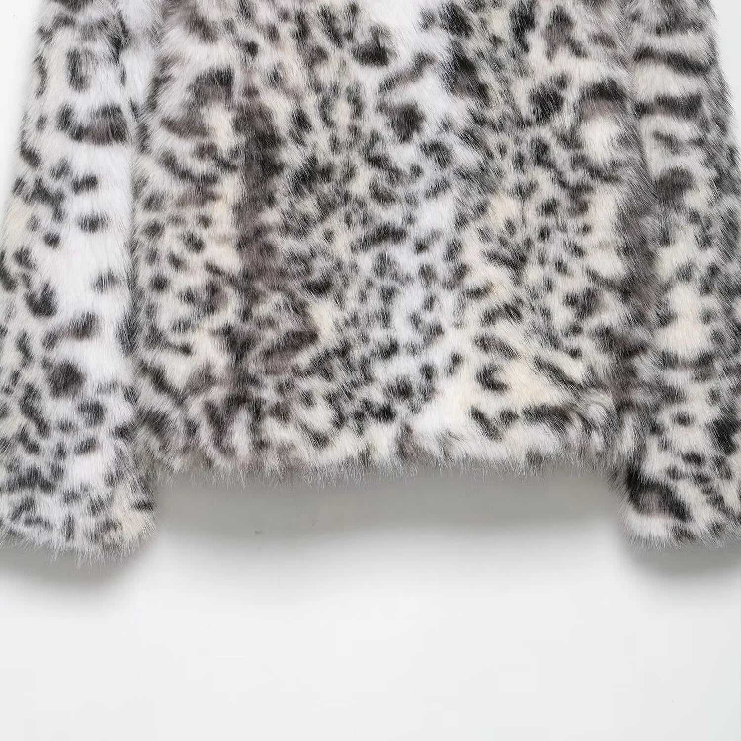 Close-up of a textured fabric with black and white pattern on a white background