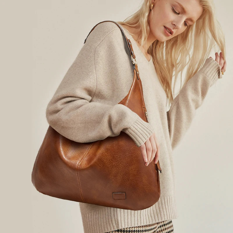 Model holding luxe winter travel handbag in winter coat