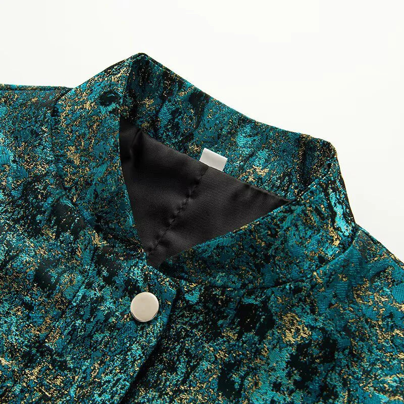 Teal and gold patterned fabric with a black satin lining and button detail on a white background