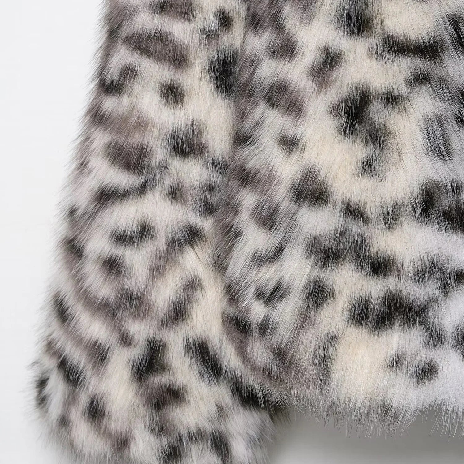 Close-up of a fur fabric with a snow leopard pattern on a white background