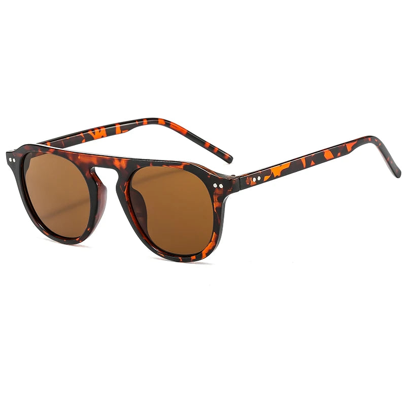Steampunk Oval Rivet Shades – Retro Gothic Industrial Goggles
with tortoiseshell frame and brown lenses on a white background