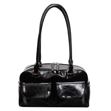 Black handbag with a glossy finish on a white background