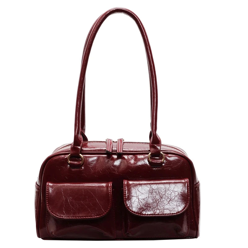 Maroon handbag with a cracked pattern on a white background