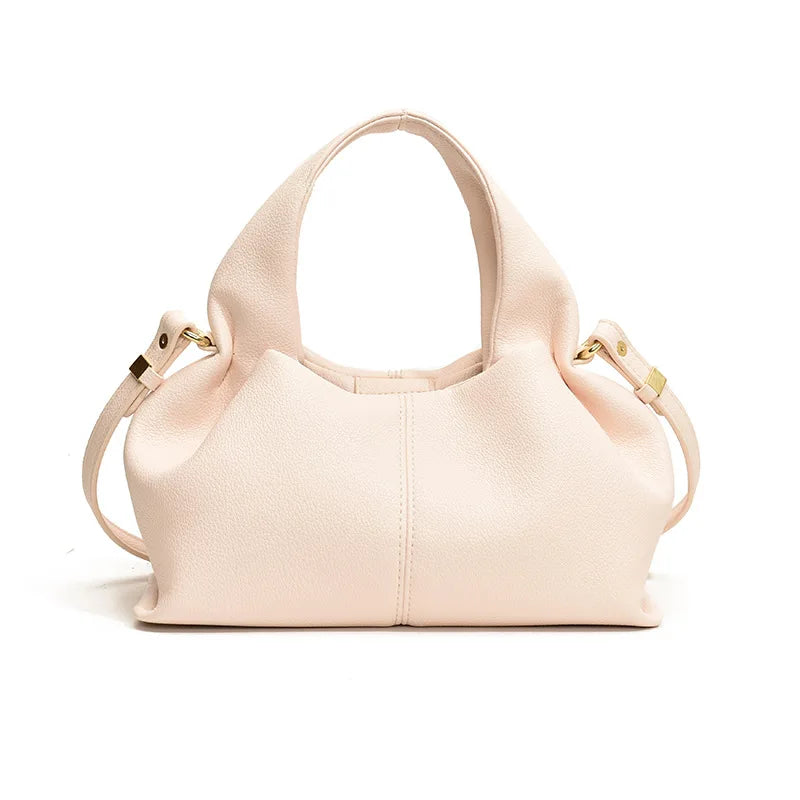 Beige handbag with gold accents on a white background