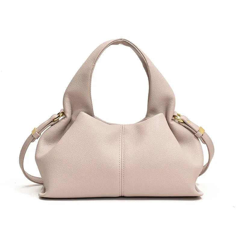 White handbag with gold accents on a white background