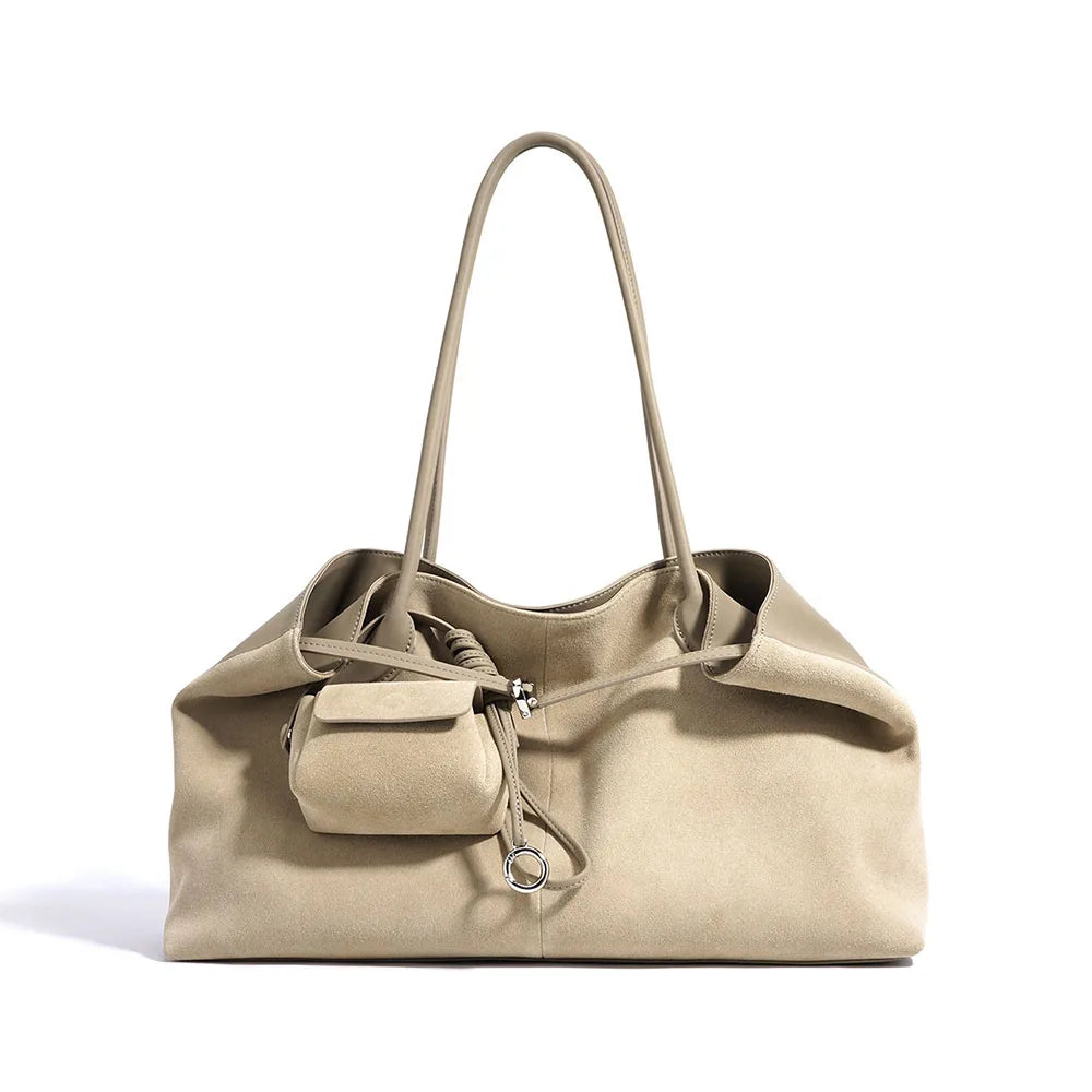 Beige handbag with a smaller attached pouch on a white background