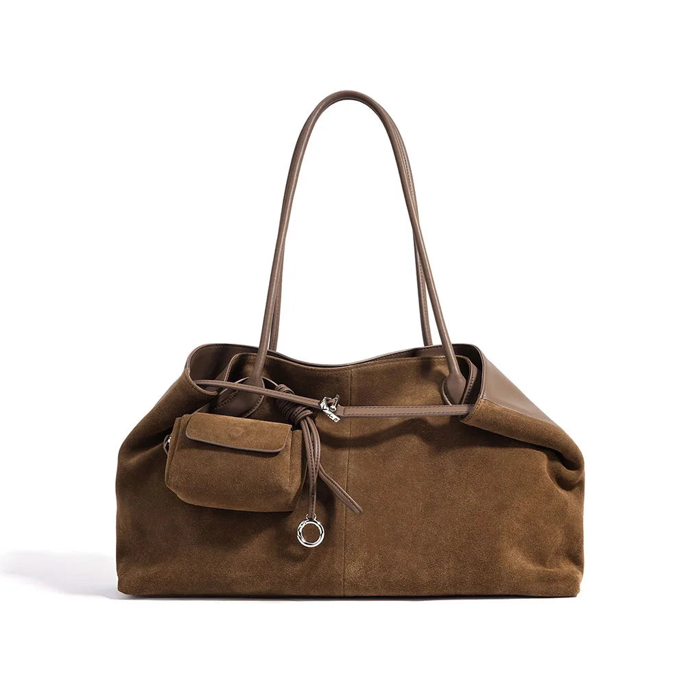 Brown suede handbag with a small pocket on a white background