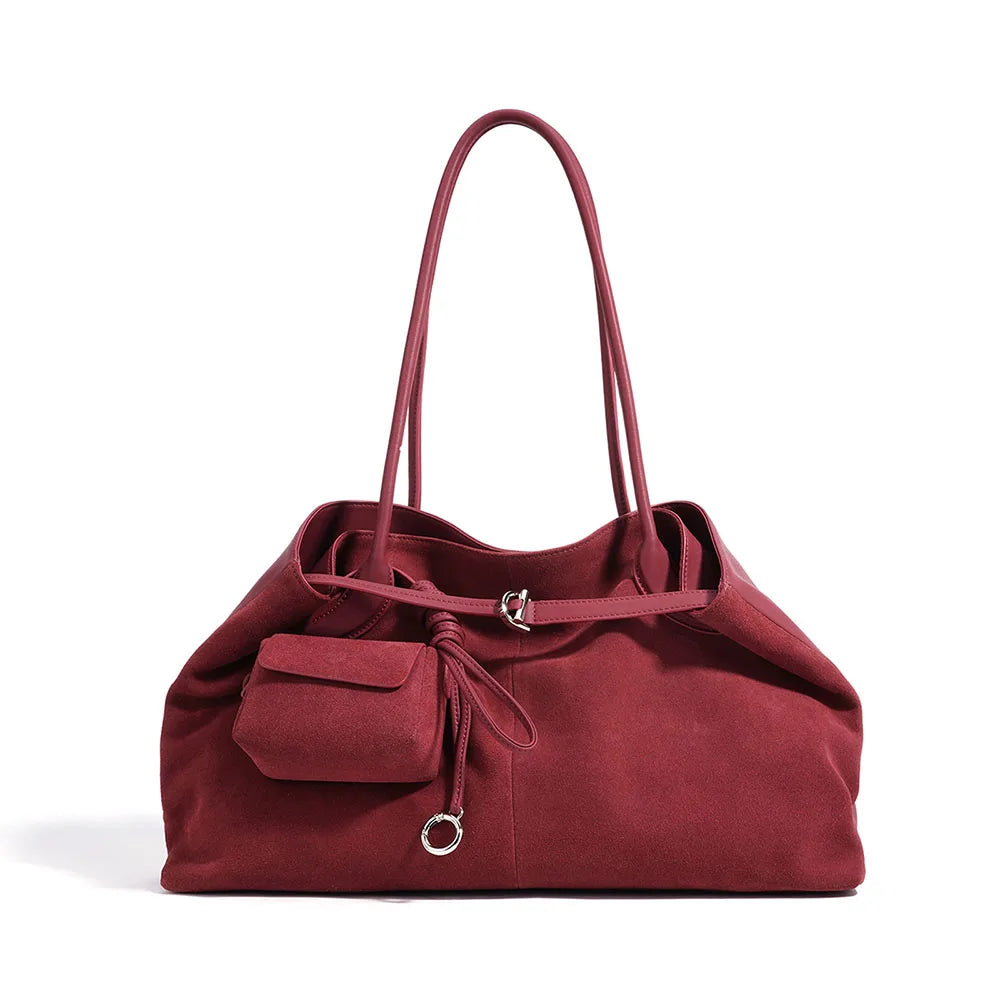 Red handbag with a strap on a white background