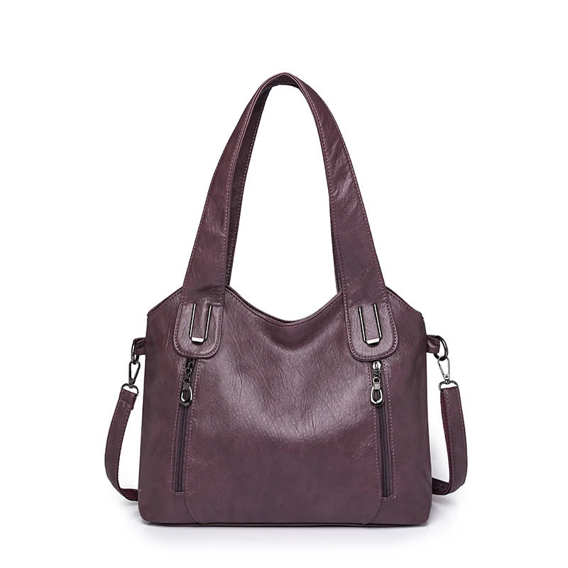 Purple handbag with multiple pockets and zippers on a white background