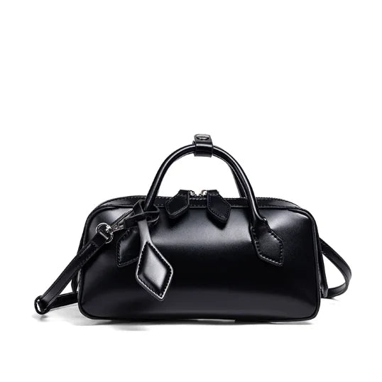 Black handbag with bow detail on a white background