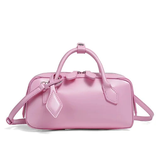 Pink handbag with a bow detail on a white background