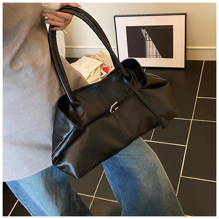 Person holding a Trendy Large Fashion Tote in a room with a tiled floor and framed picture on the wall.