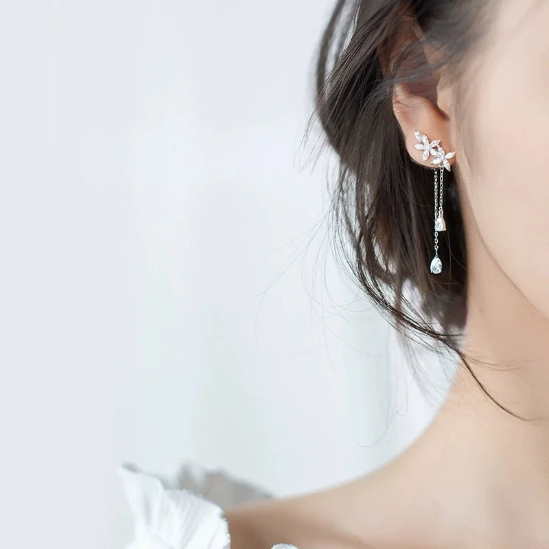 Close-up of a woman wearing Silver Tassel Flower Earrings highlighting elegance and charm.