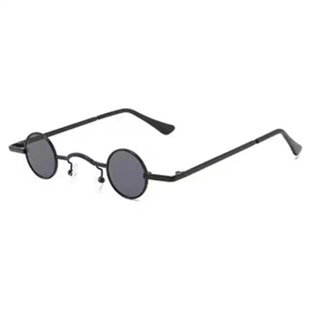 Candy Round Metal Shades Round sunglasses with black frames and dark lenses on a white background