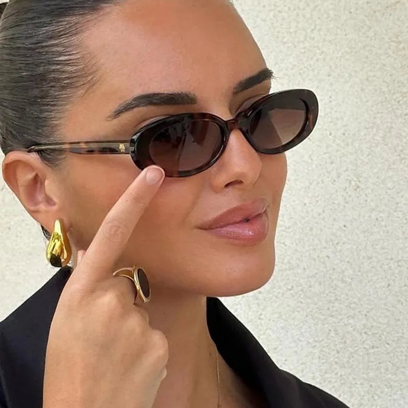 Woman wearing sunglasses with a neutral backgroundand Retro Chic Oval Shades