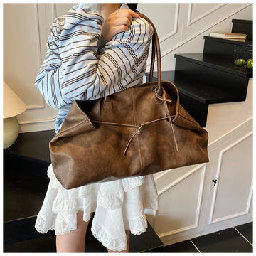 Person holding a Trendy Large Fashion Tote in an indoor setting
