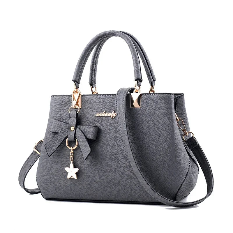 model wearing blossom charm messenger bag with dress