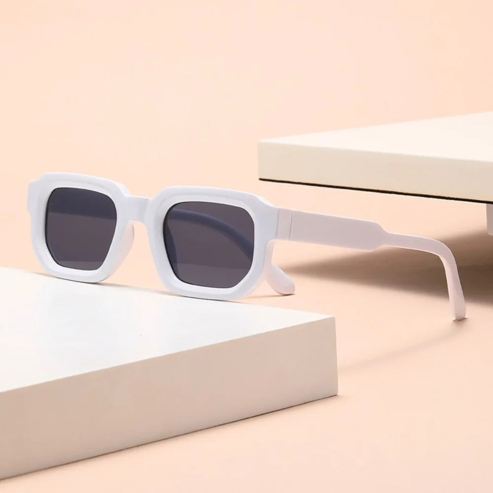 White sunglasses with dark lenses on a beige surface Leopard Punk Square Shades