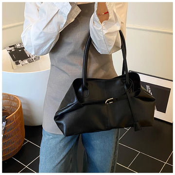 Person holding a Trendy Large Fashion Tote in an indoor setting