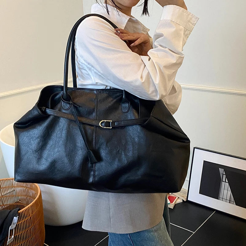 Person holding a Trendy Large Fashion Tote in an indoor setting