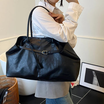 Person holding a Trendy Large Fashion Tote in an indoor setting
