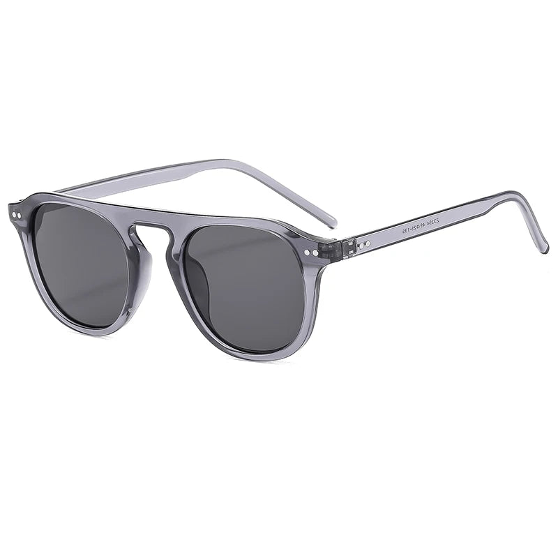 Sunglasses with gray frames and dark lenses on a Steampunk Oval Rivet Shades – Retro Gothic Industrial Goggles
