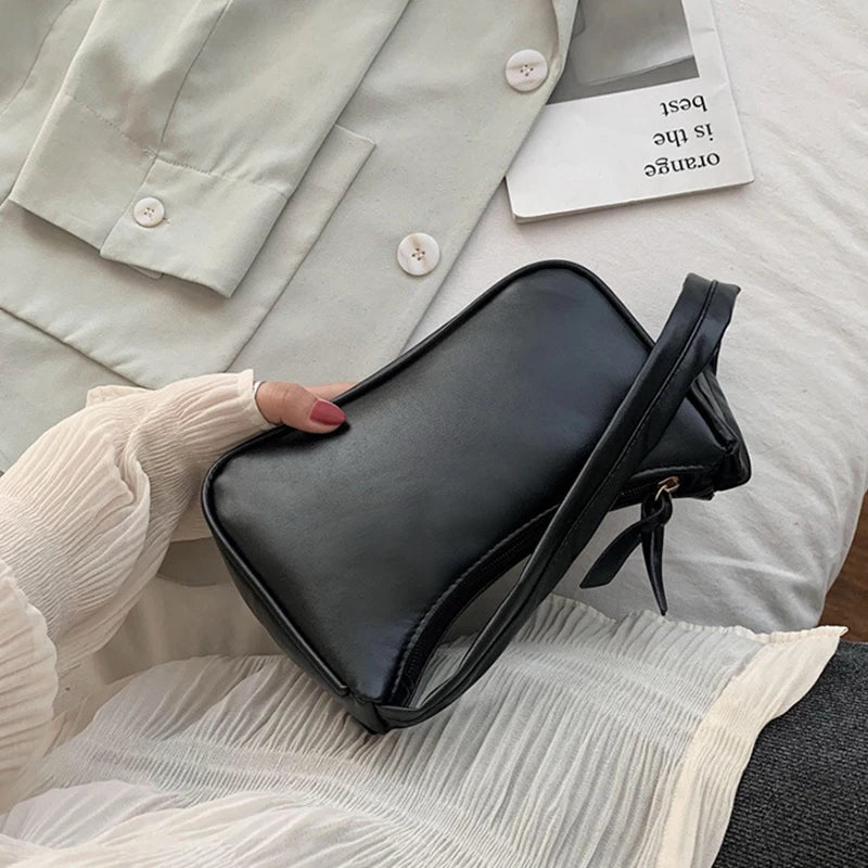 Woman holding classic retro bow leather handbag