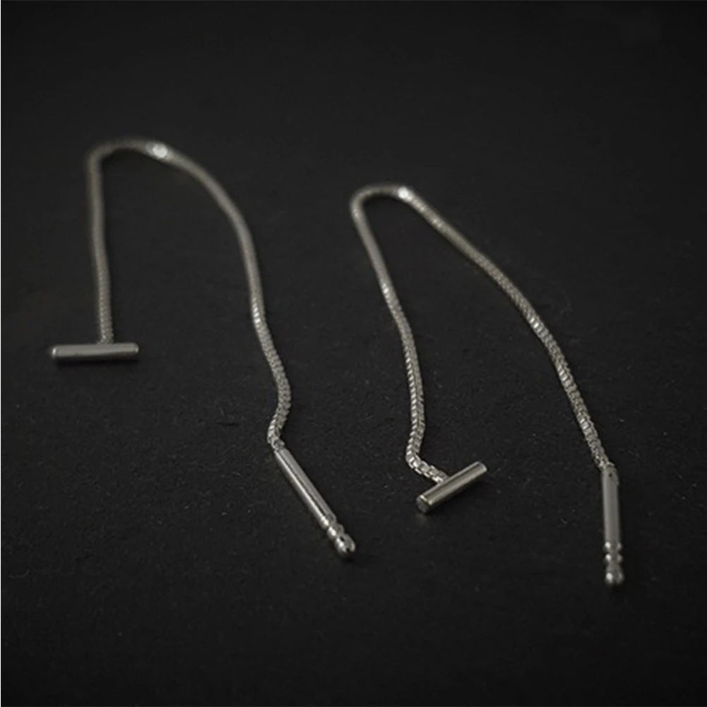 Silver earrings on a black background and  Silver Minimalist Tassel Earrings