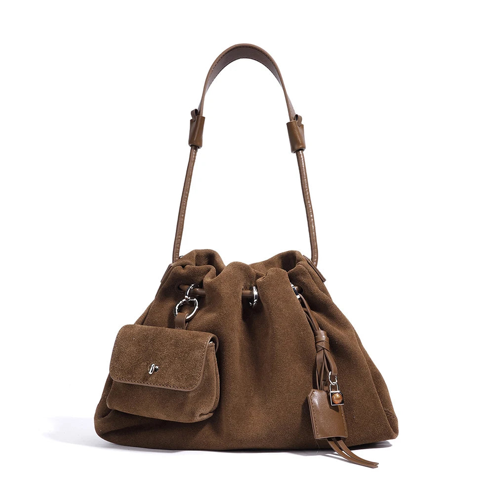 Brown suede handbag with a shoulder strap on a white background
