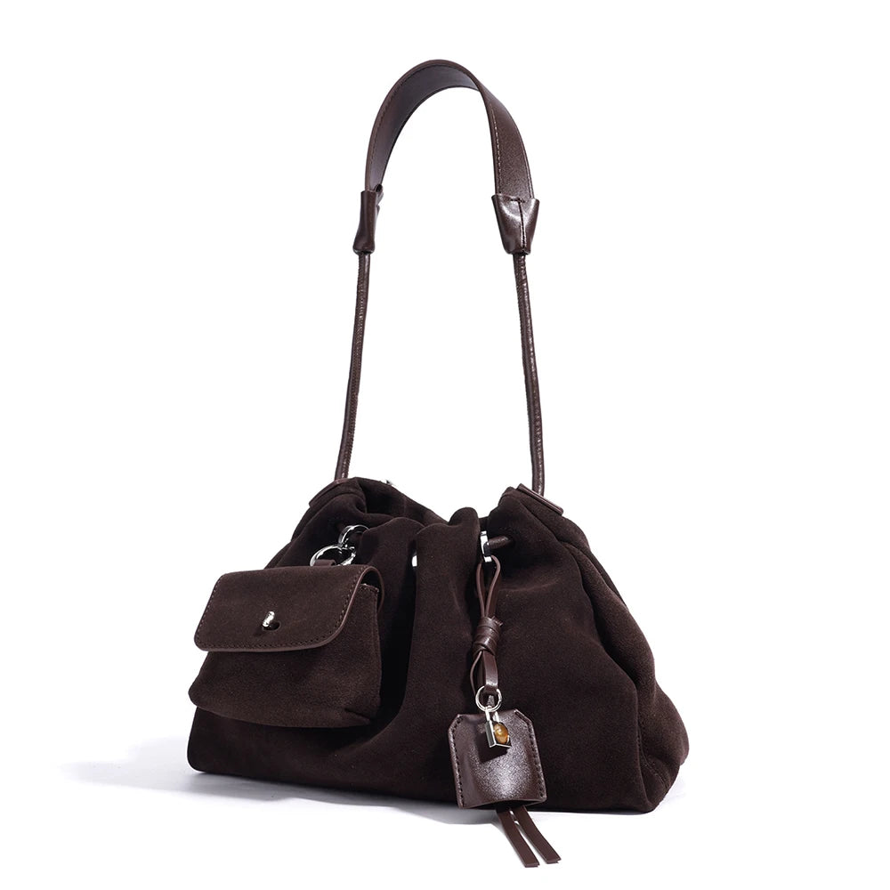 Coffee suede handbag with leather handle on a white background