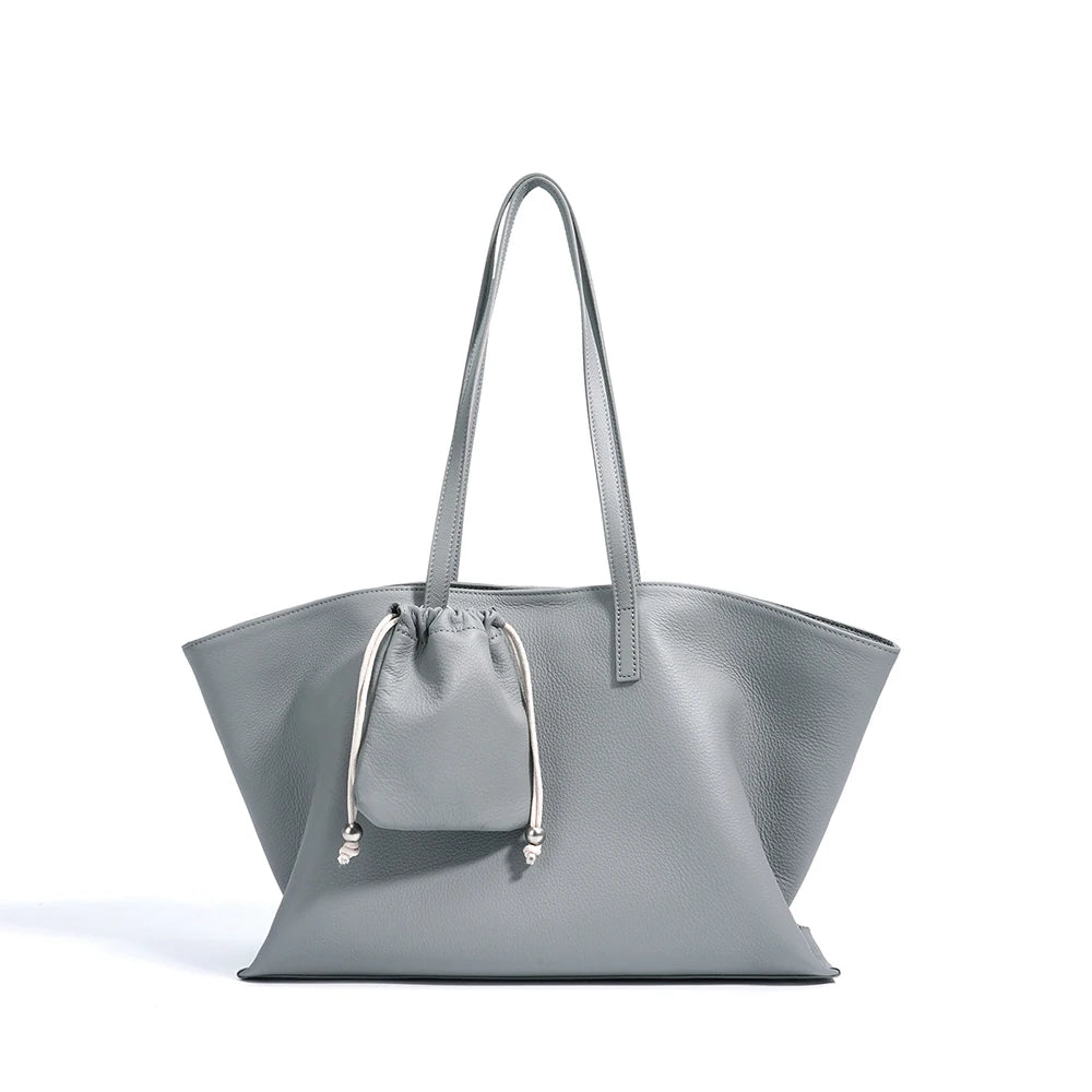 Gray handbag with a smaller matching pouch on a white background
