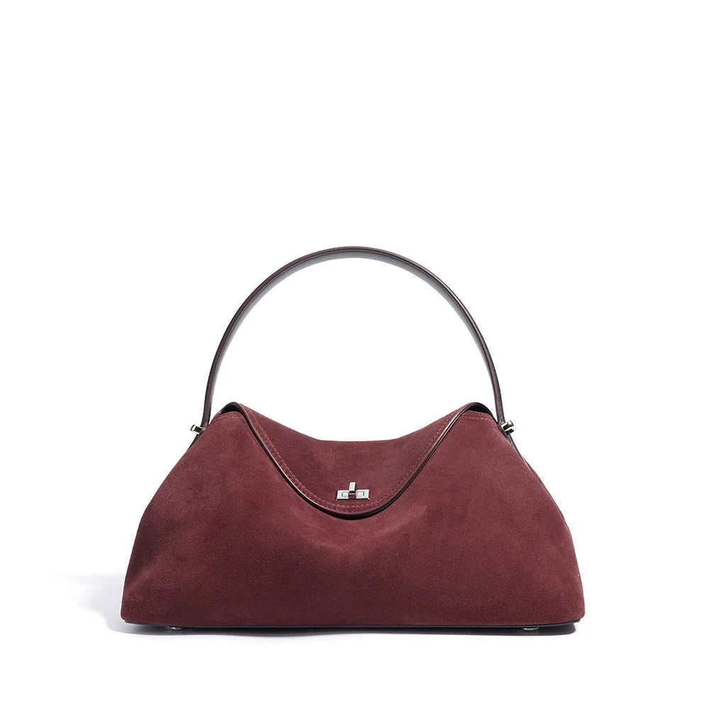 Maroon handbag with a black handle on a white background